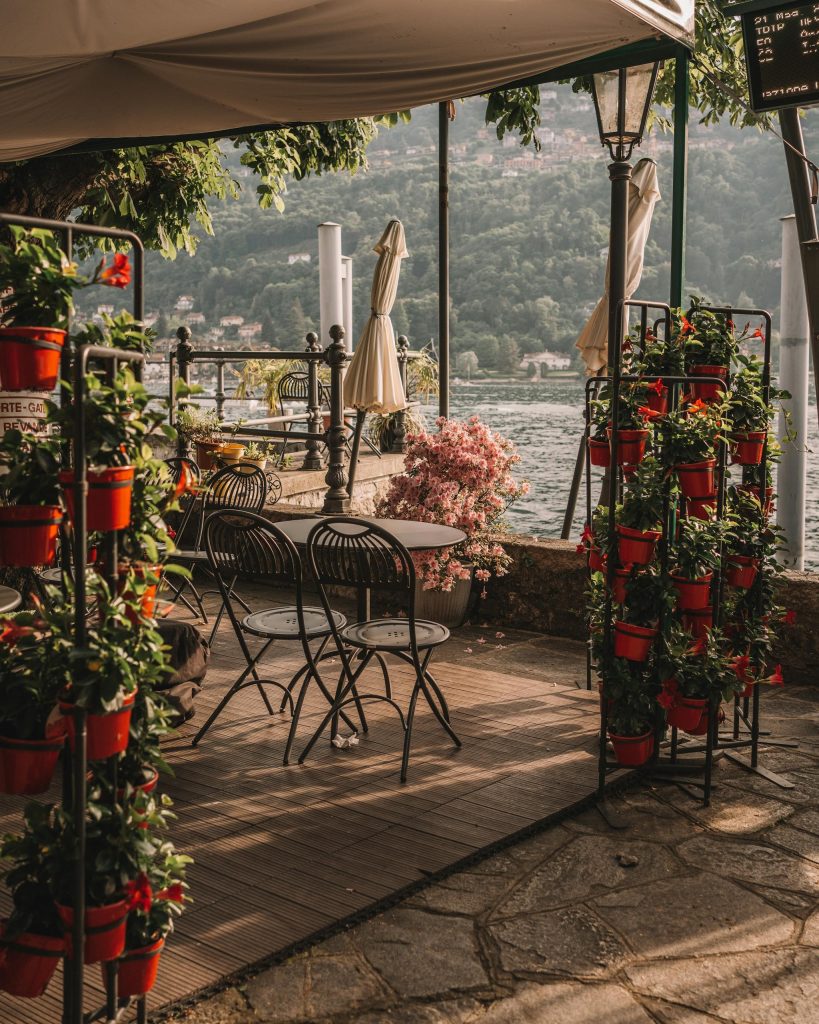 Tranquil patio with flowers overlooking Lake Maggiore in Stresa, Italy during summer.